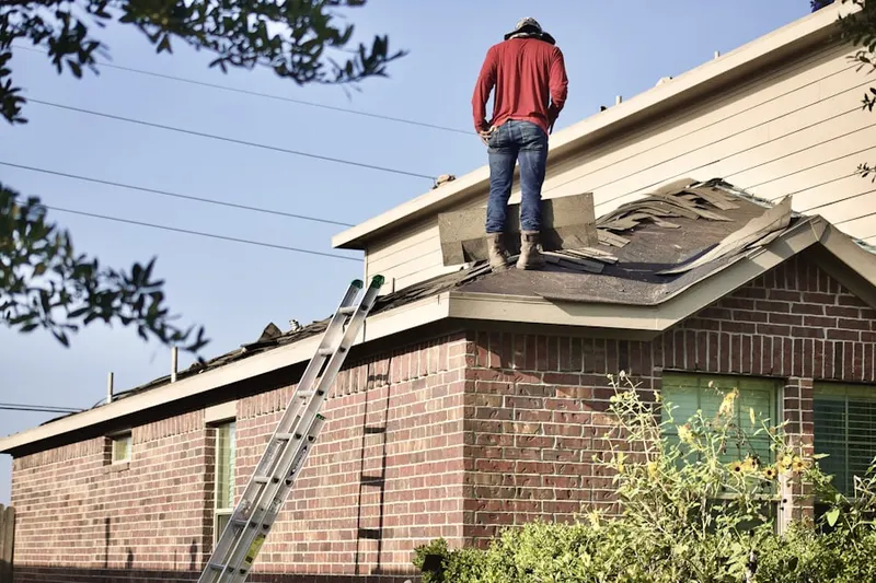 Professional roofer working on a residential roof in Winterville